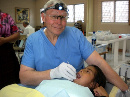 Dr. Lee Olson numbs a young Guatemalan girl for dental work.